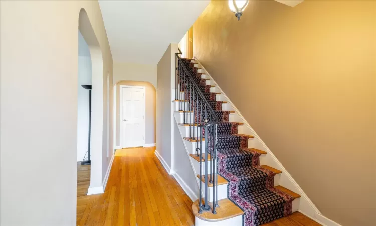 Staircase featuring hardwood / wood-style floors