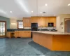 Kitchen with light stone counters, sink, a wealth of natural light, and black appliances