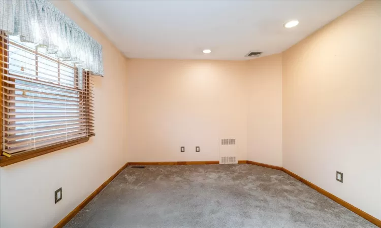 Spare room with radiator heating unit and carpet floors