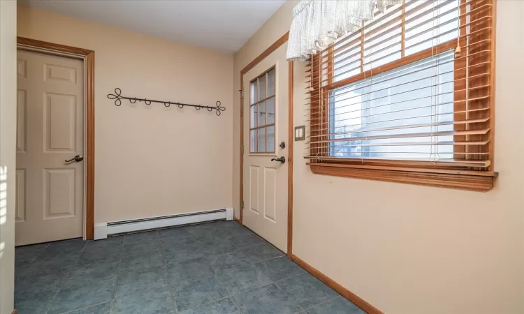 Entryway featuring a baseboard radiator