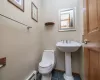 Bathroom featuring toilet and tile patterned flooring