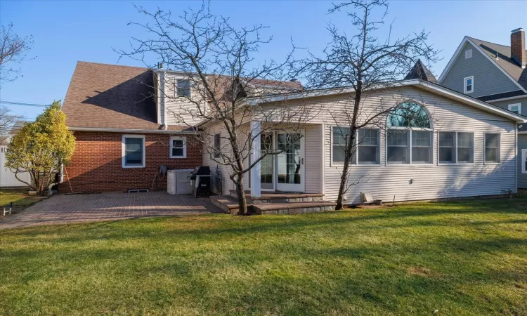 Back of house featuring a patio area and a yard