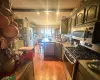 Kitchen with wood-type flooring, hanging light fixtures, sink, a breakfast bar, and stainless steel appliances