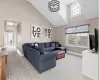 Living room featuring plenty of natural light and a towering ceiling