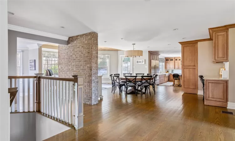 Dining area featuring dark hardwood / wood-style floors and crown molding