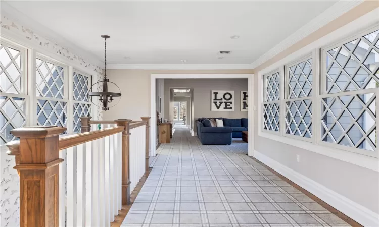 Hall with crown molding and hardwood / wood-style floors