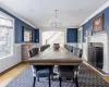 Dining room with a chandelier, ornamental molding, hardwood / wood-style floors, and decorative columns