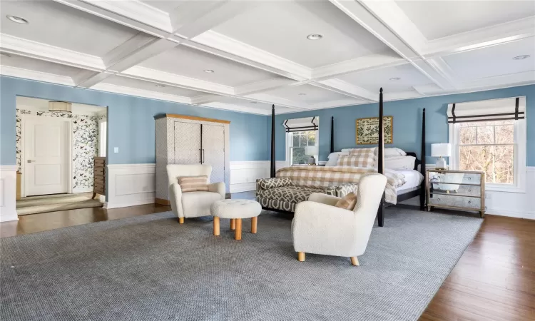 Bedroom with dark hardwood / wood-style flooring, crown molding, beam ceiling, and coffered ceiling