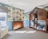 Bedroom featuring light colored carpet and crown molding