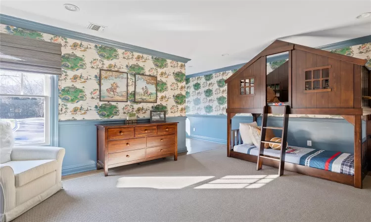 Bedroom featuring light colored carpet and crown molding