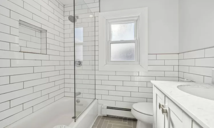 Full bathroom with tiled shower / bath, and double vanity