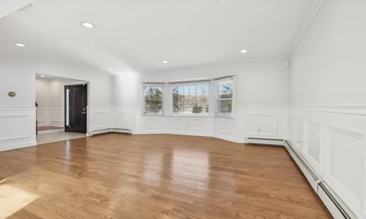 Living room with hardwood floors and custom moldings