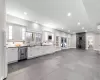 Kitchen with dishwasher, decorative backsplash, white cabinetry, a wood stove, and white refrigerator