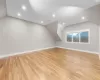 Bonus room with vaulted ceiling and light hardwood / wood-style flooring