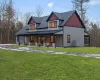 View of front facade featuring a front lawn and a porch