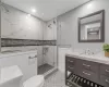 Bathroom featuring toilet, vanity, a shower with shower door, and a wall mounted air conditioner