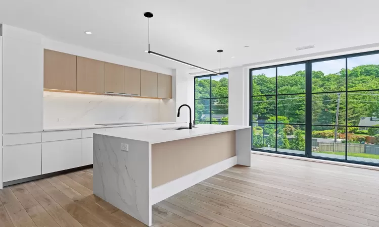 Similar kitchen with floor-to-ceiling windows.