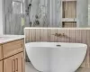 BUILDER PRIOR WORK - Bathroom with vanity, tile patterned floors, tile walls, and separate shower and tub