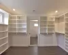 BUILDER PRIOR WORK - Spacious closet with dark hardwood / wood-style flooring