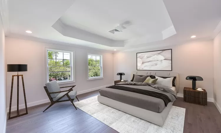 BUILDER PRIOR WORK - Bedroom with hardwood / wood-style floors, a tray ceiling, and crown molding