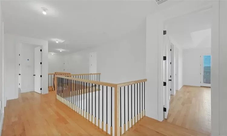 Corridor with light hardwood / wood-style floors