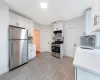 Kitchen featuring white cabinets, stainless steel appliances, tasteful backsplash, and sink