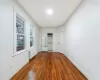 Unfurnished Bedroom #1 with radiator heating unit and dark wood-type flooring