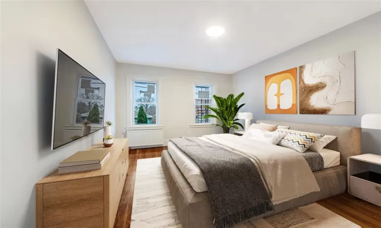 Virtually Staged Bedroom #2 featuring radiator and hardwood / wood-style floors