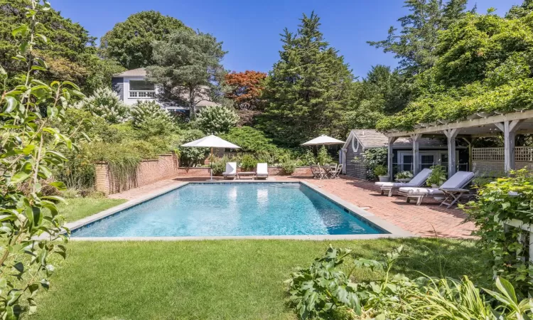 View of swimming pool with a patio area and a lawn