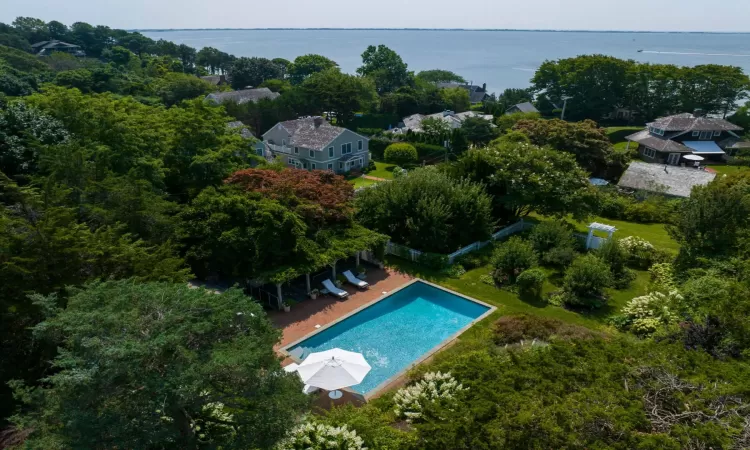 Birds eye view of property with a water view