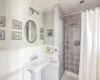 Bathroom featuring curtained shower and toilet