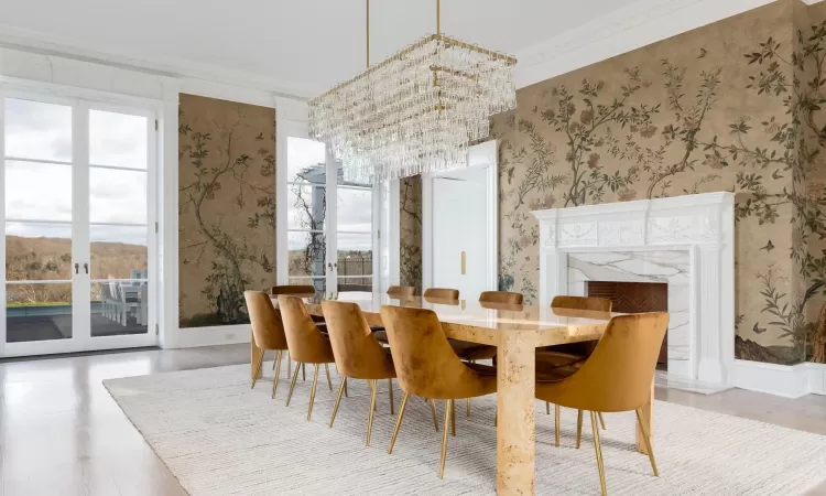 Dining area featuring a chandelier, french doors, ornamental molding, and wood-type flooring