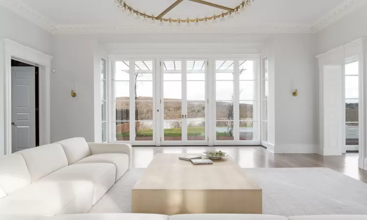 Living room with crown molding and light hardwood / wood-style flooring