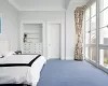 Bedroom with multiple windows and carpet flooring