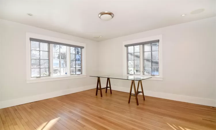 dining area with French doors to patio and yard, a wealth of natural light, and light hardwood flooring