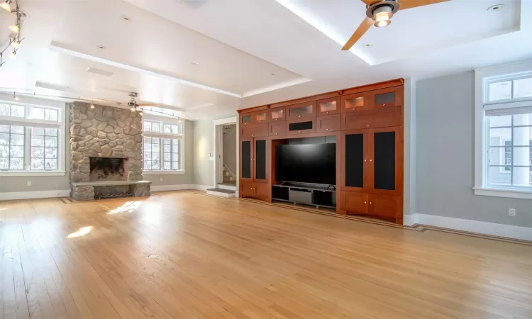 Kitchen featuring gourmet appliances, tasteful backsplash, and a center island with sink