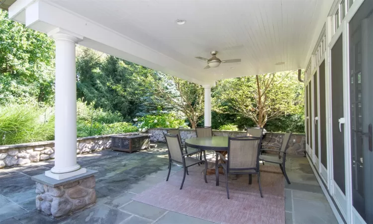 View of patio with ceiling fan, an outdoor fire pit, and grilling area