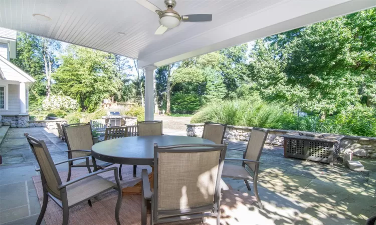 View of patio / terrace with grilling area and an outdoor living space with a fire pit