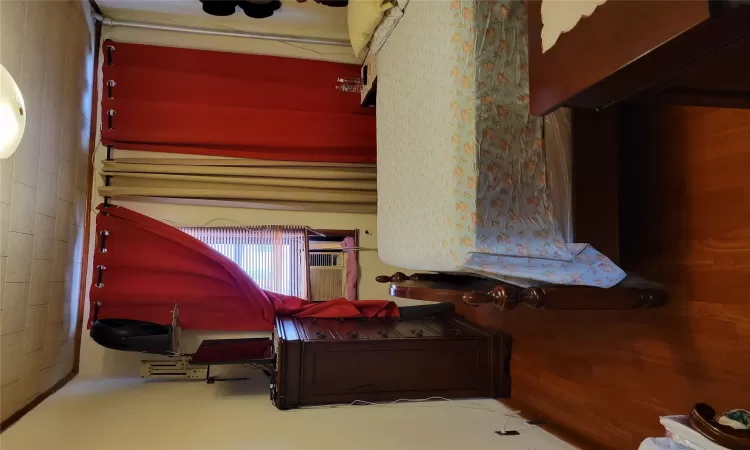 Bedroom with dark wood-type flooring and ornamental molding