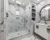 Bathroom with vanity and a shower with door