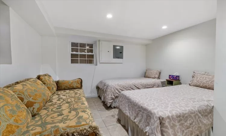 Tiled bedroom with electric panel