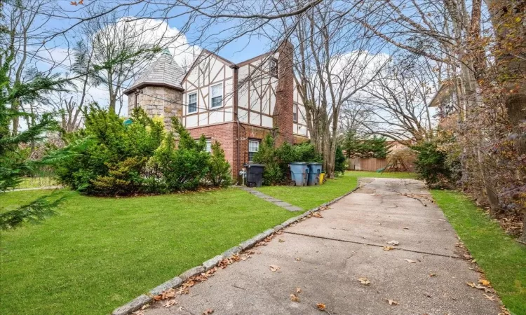 View of property exterior with a yard