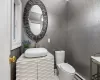 Bathroom with vanity, ornamental molding, toilet, and baseboard heating