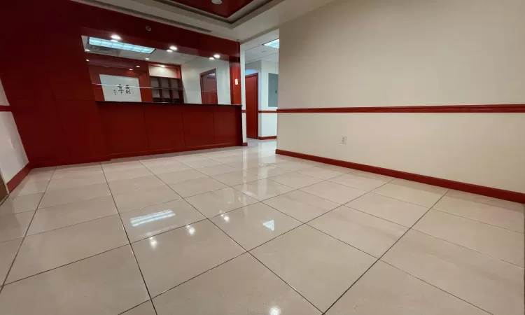 Unfurnished room featuring light tile patterned floors