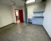 Kitchen with a drop ceiling, sink, and light tile patterned flooring