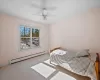 Carpeted spare room with ceiling fan and a baseboard radiator