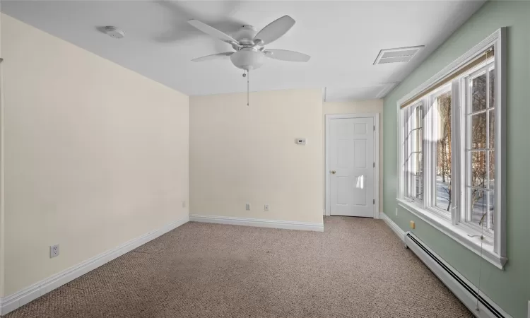 Office space featuring vaulted ceiling and light colored carpet