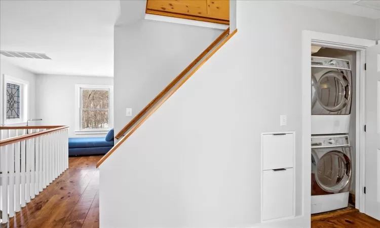 Carpeted bedroom with a baseboard radiator, vaulted ceiling, and ceiling fan