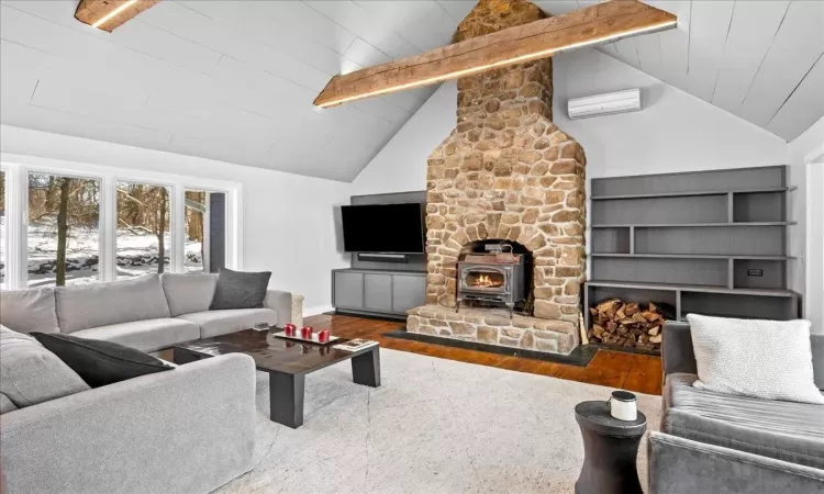 Dining area featuring indoor bar, vaulted ceiling, wine cooler, ceiling fan, and hardwood / wood-style flooring