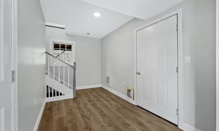 Entrance foyer with hardwood / wood-style flooring